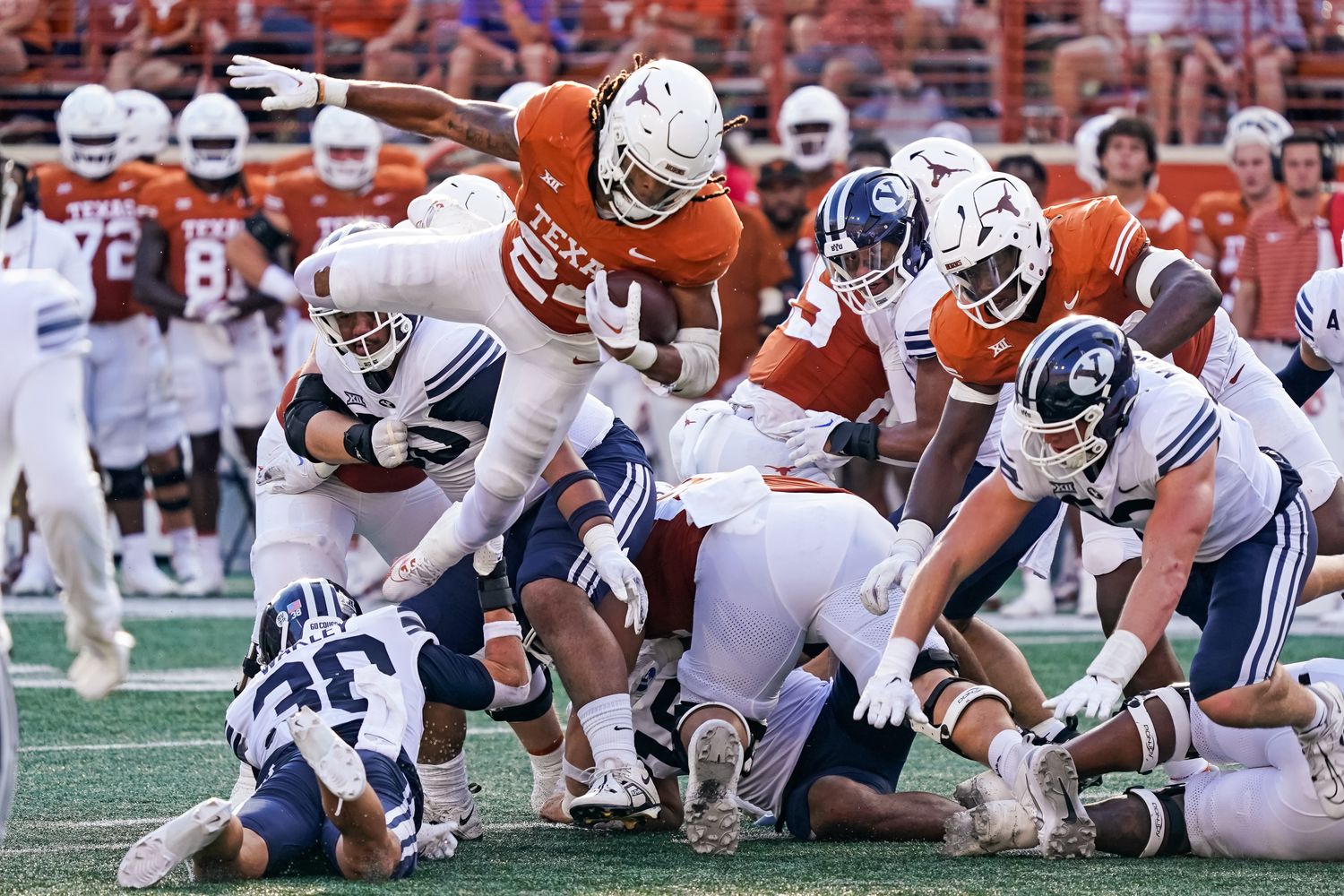 Oct 28, 2023; Austin, Texas, USA; Texas Longhorns running back Jonathon Brooks (24) leaps over Brigham Young Cougars defenders during the second half at Darrell K Royal-Texas Memorial Stadium.